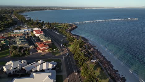 Drone-birds-eye-along-street-of-Esperance-Town-during-golden-sunset