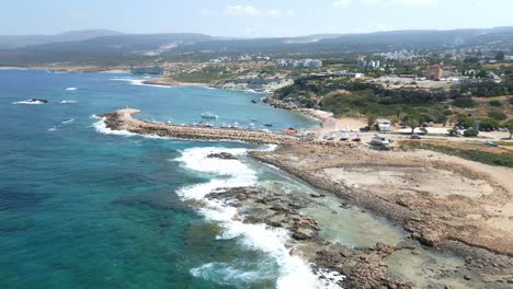 Agios-georgios-beach-in-cyprus-with-clear-blue-waters-and-rugged-coastline,-aerial-view