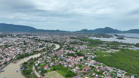 Banda-aceh-with-river-winding-through,-post-tsunami-recovery-evident-in-city-layout,-aerial-view