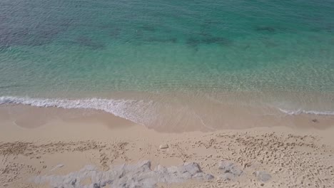 Antena-Establecida-De-Playa-De-Arena-Tropical-Con-Olas-De-Agua-Clara-Y-Prístina