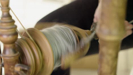 Close-up:-Bobbin-of-yarn-rotates-on-vintage-Nordic-spinning-wheel