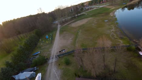 POV-shot-flying-first-person-style-over-the-coastline-of-the-Mazury-lake,-in-Poland