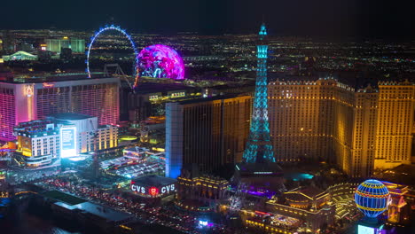 Timelapse,-Las-Vegas-Strip-at-Night,-Traffic,-Sphere,-Eiffel-Tower,-High-Roller-Ferris-Wheel-and-Casino-Hotel-Buildings