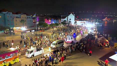 Aerial-panoramic-overview-of-Gran-Marcha-Parade-and-vibrant-colorful-buildings-at-night