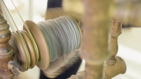 Close-up:-Bobbin-spindle-on-traditional-spinning-wheel-spins-wool-yarn