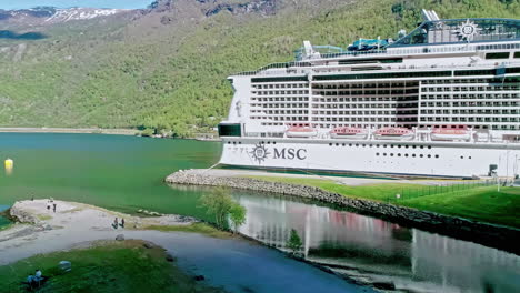Drone-shot-of-a-large-MSC-Cruise-ship-deep-in-Norway's-fjords