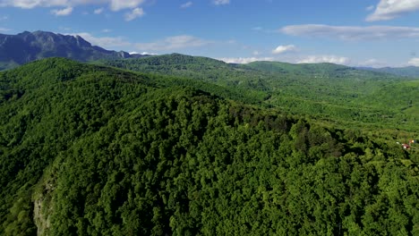 4k-cinematic-aerial-drone-stock-footage-flying-over-a-beautiful-mountain-in-a-valley-located-in-Romanian's-Carpathians-side