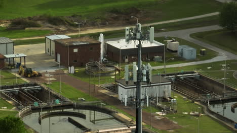 Collierville-wastewater-treatment-plant-in-tennessee,-showcasing-industrial-structures-and-surrounding-greenery,-aerial-view