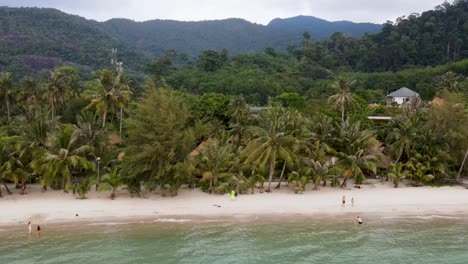 Aerial-View-Of-Kai-Bae-Beach-In-Koh-Chang-With-Palm-Trees-And-Tropical-Forest-In-Background