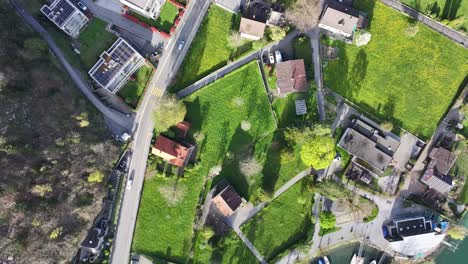 A-bird's-eye-view-captures-the-residential-area-adjacent-to-Lake-Walensee-in-Wessen,-Switzerland,-offering-insight-into-lakeside-living-and-the-harmonious-integration-of-community-and-nature