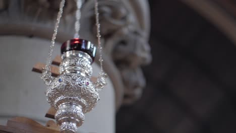Elegant-silver-censer-hanging-on-chains,-ornately-crafted