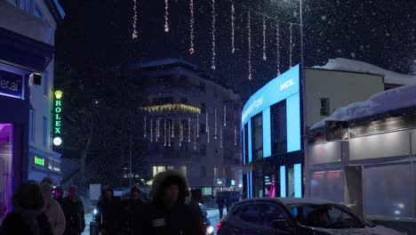 Walking-night-time-shot-showing-the-high-street-of-Davos-during-the-World-Economic-Forum-with-people-walking-past-the-camera