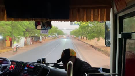 Autobús-Que-Conduce-En-La-Carretera-De-La-Aldea-Africana-A-Wulugu,-Carretera-De-Hormigón-Asfaltada-Sin-Tráfico