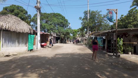 Walking-pov-along-rural-small-town-road-with-people-crossing-by-and-local-business-stores-in-Palomino