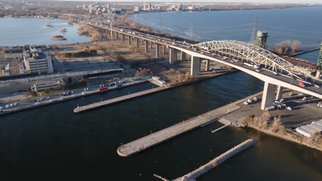 The-skyway-bridge-in-hamilton,-ontario-with-traffic-and-bay-area,-daylight,-aerial-view