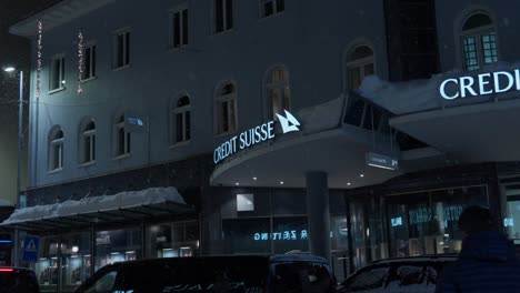 Right-to-left-night-time-panning-shot-showing-a-Credit-Suisse-branch-in-Davos-during-the-World-Economic-Forum