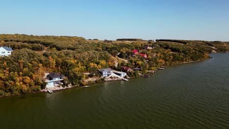 Slow-Drone-Shot-Luxury-Lakefront-Properties-with-docks-amidst-multicolor-trees