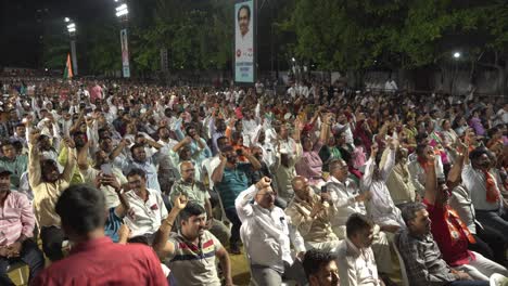 Large-crowd-of-Indian-people-cheering-and-slogan-shouting-during-Lok-Sabha-election-campaign-by-Uddhav-Thackeray-and-Sharad-Pawar-at-college-ground-in-Warje