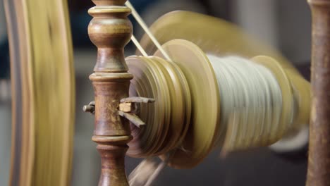 Closeup-detail:-Vintage-Nordic-spinning-wheel-bobbin-full-of-wool-yarn