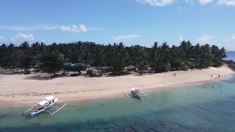 Beach-vacationers-enjoying-Tropical-nature-on-remote-Corregidor-island-in-Siargao,-Drone