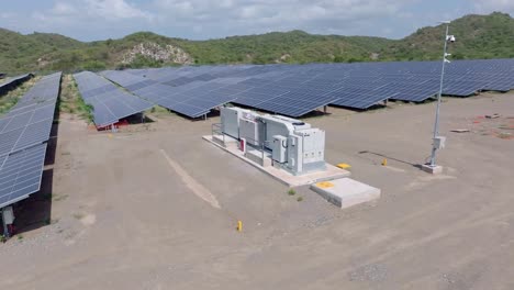 Battery-system-to-store-solar-energy-surrounded-by-solar-panels,-Bani