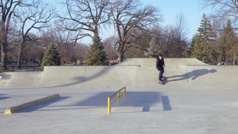 Mann-Im-Skatepark-Macht-Einen-Grind,-Dreht-Dann-Das-Skateboard-Um-Und-Landet