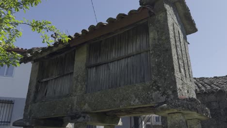 Traditional-Granary-Old-Wooden-Wall-And-Roof-Tiles-In-The-Sun-Galicia-Spain