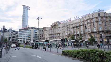 Bustling-city-street-scene-with-pedestrians-and-modern-architecture,-daytime