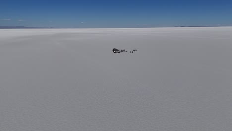 people-and-cars-on-Salar-de-Uyuni-Bolivia-South-america-desert-salt-flats-landscapes-aerial-drone-view-mountains