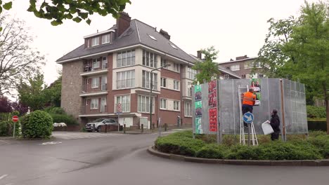 Municipal-workers-hanging-up-photos-of-political-leaders,-candidates-and-parties-for-the-Belgian-elections-on-June-9th-2024---Brussels,-Belgium