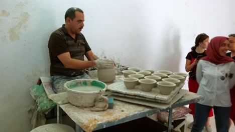 Moroccan-artisan-shapes-clay-pots-using-the-wheel-throwing-technique-in-traditional-handicraft-manufacturing-in-Fes