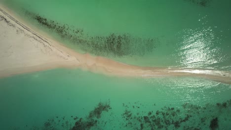 Turquoise-waters-embrace-a-sandy-path-in-Cayo-de-Agua,-aerial-view