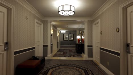 Empty-hallway-in-luxury-hotel-with-mirrors-and-red-lamps,-interior-design