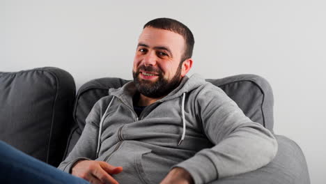 Happy-Man-Sofa-Smiling-And-Pointing-At-Camera---You-Got-This-Gesture