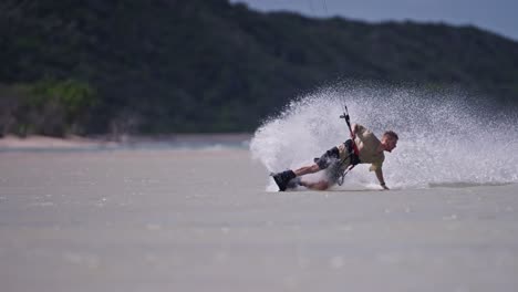 Slow-motion-tracking-pan-follows-kiteboard-surfer-turning-tight-spraying-water