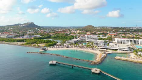 Empty-port-dock-at-harbor-for-cruise-ships-with-protected-cove-beach,-Curacao