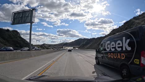 Sunlit-highway-with-scattered-clouds-and-driving-cars,-time-lapse-perspective-from-vehicle