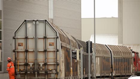 Freight-trains-lined-up-at-an-industrial-depot-during-the-day,-showing-a-busy-transportation-hub