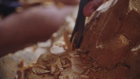 Asian-Wood-Carver-Working-On-Traditional-Balinese-Barong-Mask-In-Bali,-Indonesia---Close-Up