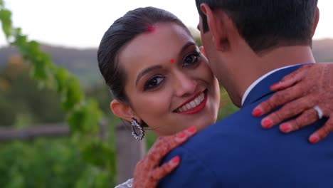 Close-Up-Of-Indian-Bride-Hugging-Her-Groom-Looking-At-The-Camera,-Indian-Couple-On-Their-Wedding-Day