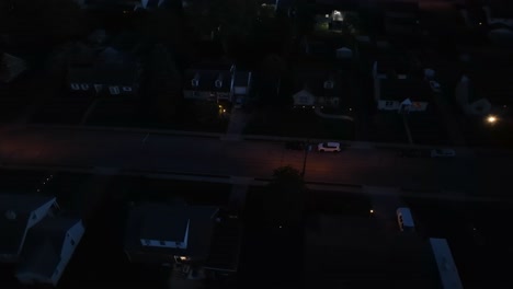 Aerial-top-down-shot-of-lighting-lantern-on-main-street-of-dark-neighborhood-at-night,-USA