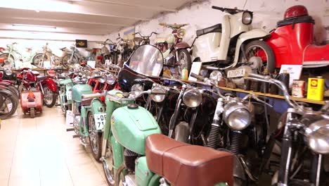 Walking-down-row-of-vintage-motorcycles-on-display-in-museum,-Hungary