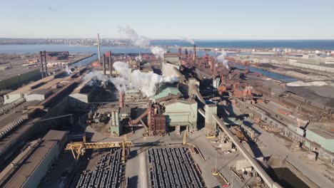 Hamilton's-industrial-sector-with-factories-and-smokestacks,-aerial-view