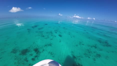 Crystal-clear-turquoise-waters-with-a-calm-surface-under-a-sunny-sky,-POV-shot-sailing-on-the-sea