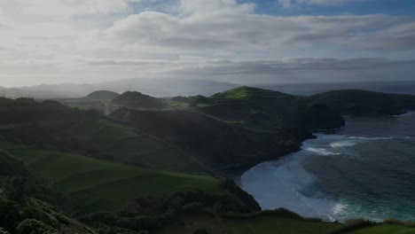 aerial-view-of-picturesque-coastal-landscape-of-the-Azores,-Portugal,-featuring-a-beautiful-beach-juxtaposed-with-lush-green-fields