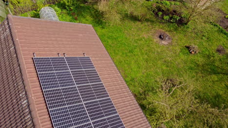 New-installed-solar-panels-on-rooftop-of-country-home,-aerial-view