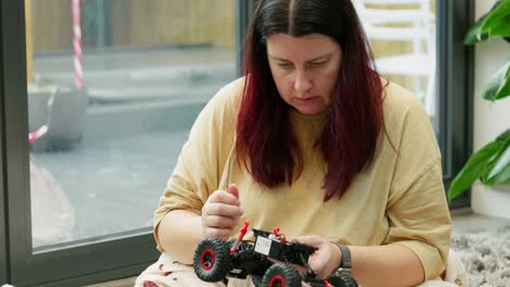 Mother-and-son-on-Christmas-morning-building-a-new-toy-car