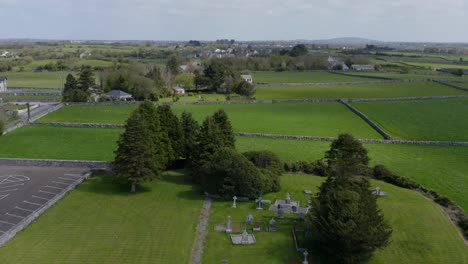 Cargin-Church-cemetery-with-group-of-trees-along-stone-wall,-aerial