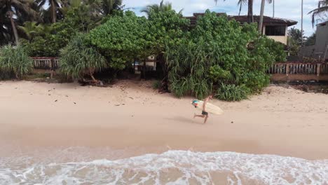 Athletic-Male-Surfer-Running-Along-Sandy-Beach-in-Sri-Lanka