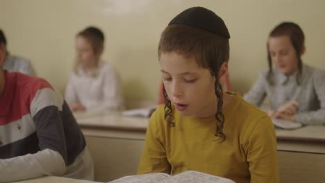 ultra--Orthodox-Jewish-students-with-a-kippahs-lerning-in-class